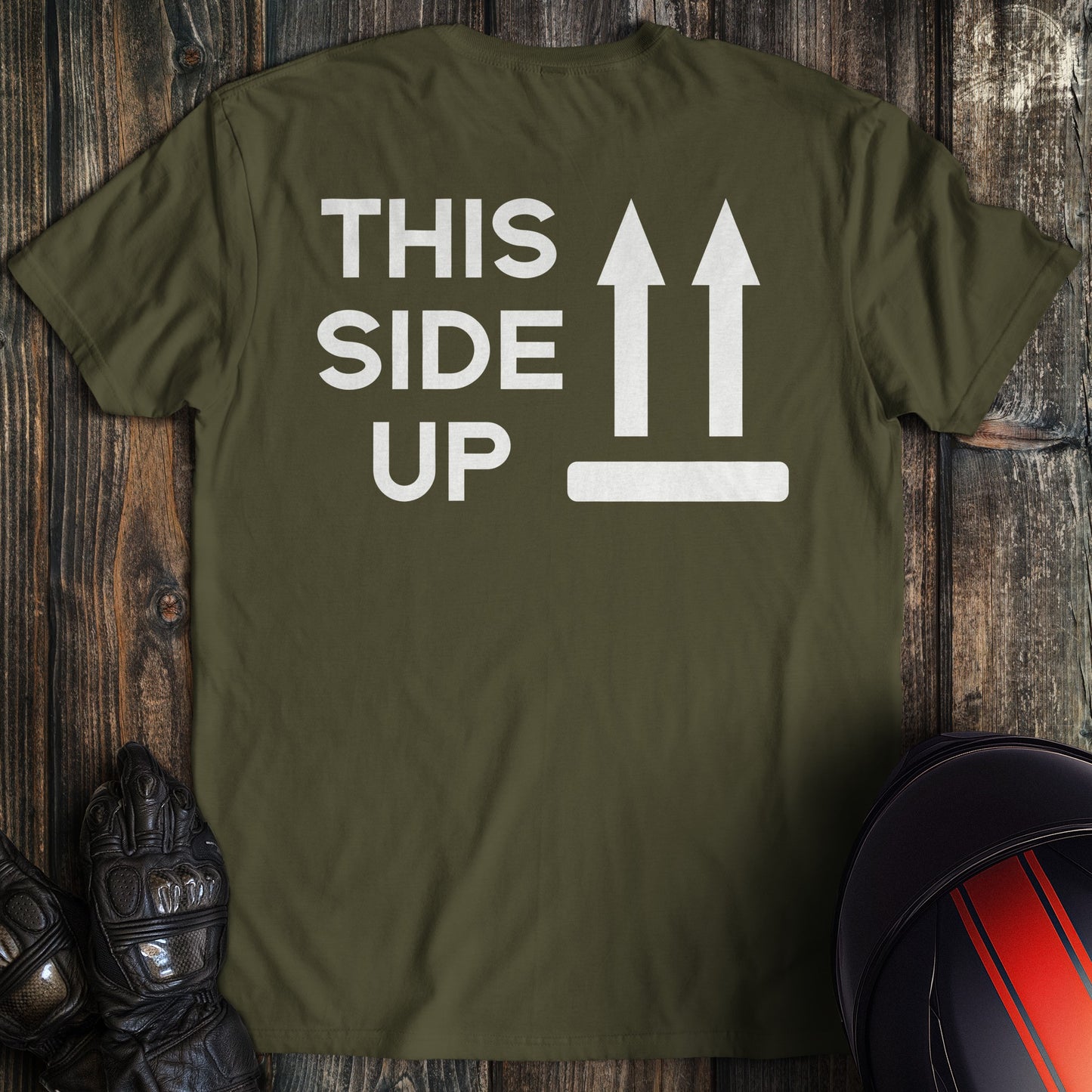 A military green colored t-shirt with the words "this side up" printed on the back.