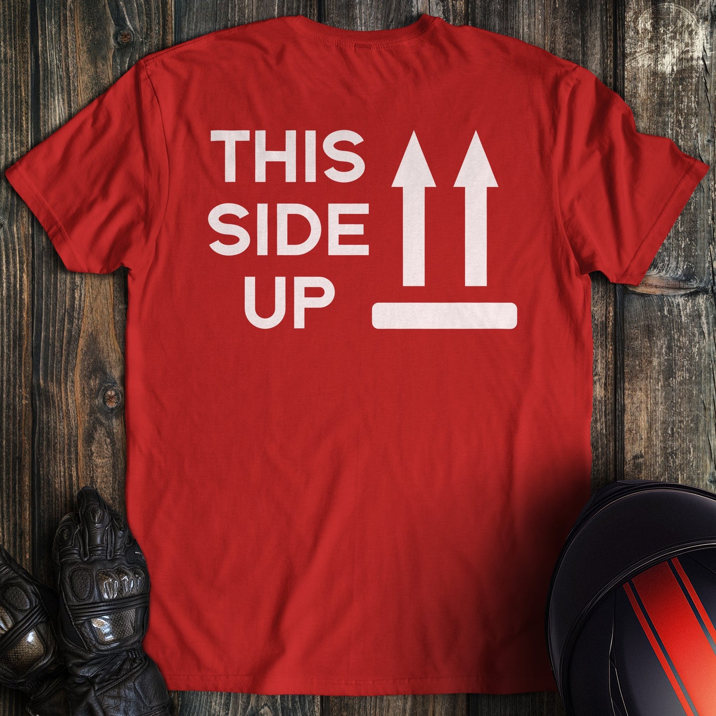A red colored t-shirt with the words "this side up" printed on the back.