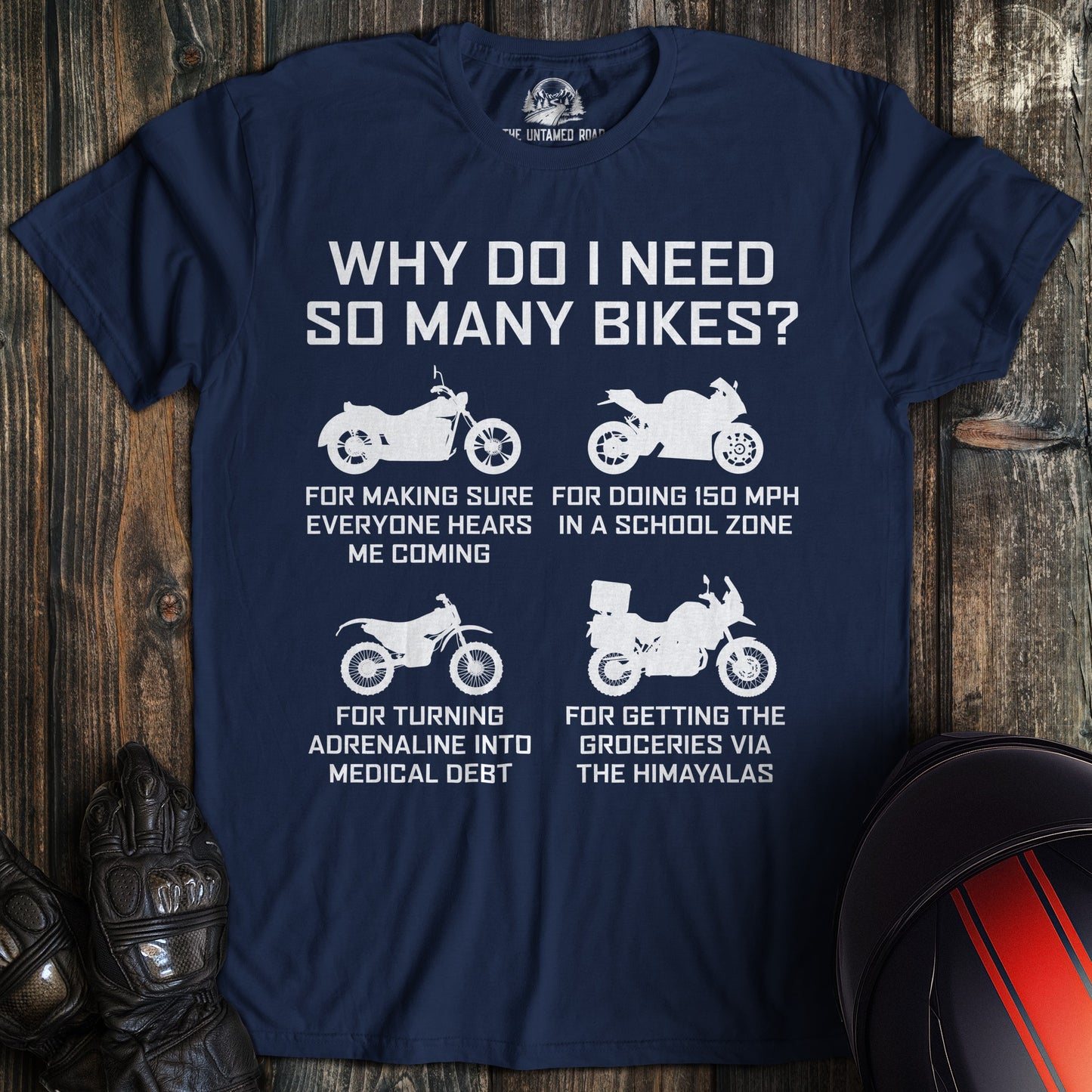 A navy blue t-shirt featuring four motorcycle silhouettes and funny text explaining the need for multiple bikes.