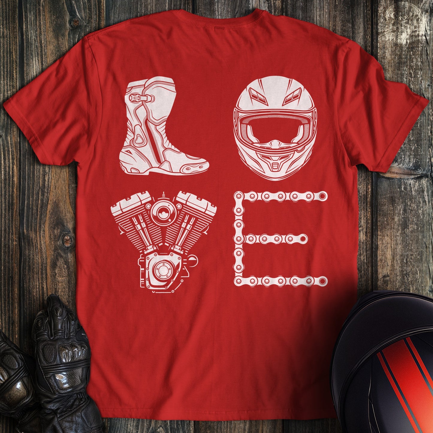 A red t-shirt featuring the word LOVE spelled with a motorcycle boot, helmet, engine, and chain in white.