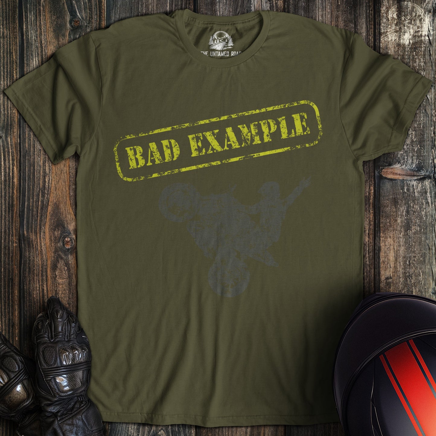 A military green colored t-shirt with the words "bad example" printed on the front.