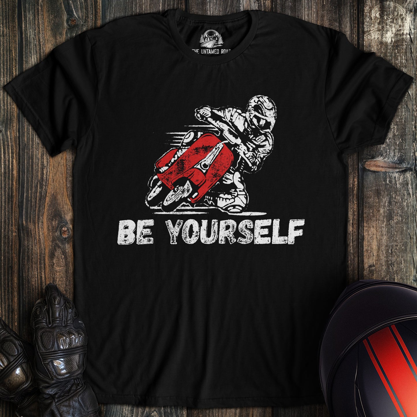 A black colored t-shirt with the words "be yourself" printed on the front.