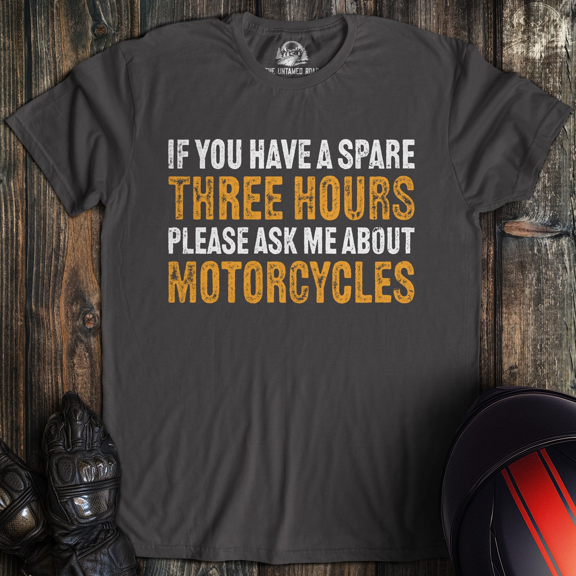 A charcoal gray t-shirt with the text 'If you have a spare three hours please ask me about motorcycles'.