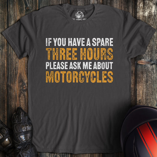 A charcoal gray t-shirt with the text 'If you have a spare three hours please ask me about motorcycles'.