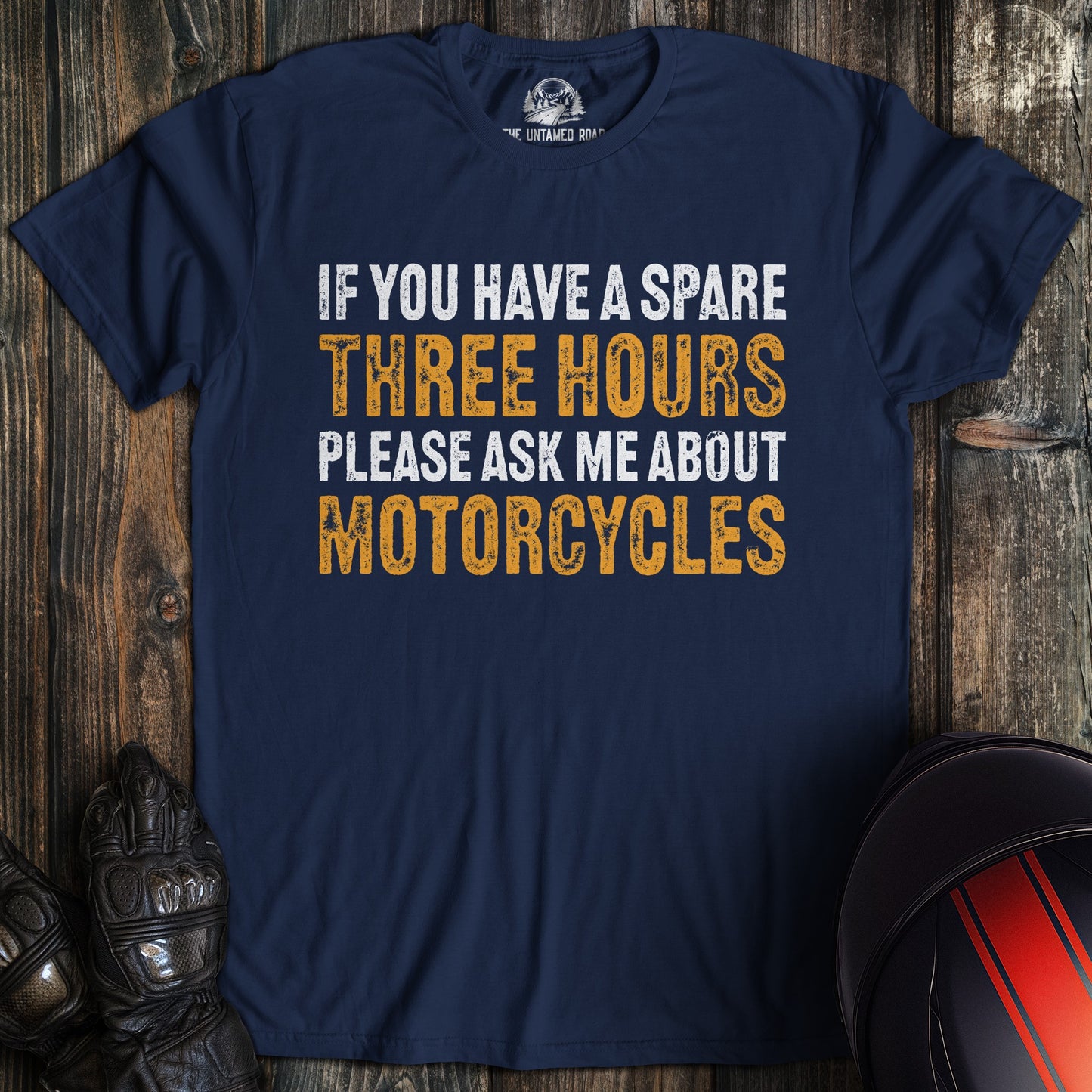 A navy blue t-shirt with the funny text, If you have a spare three hours please ask me about motorcycles.