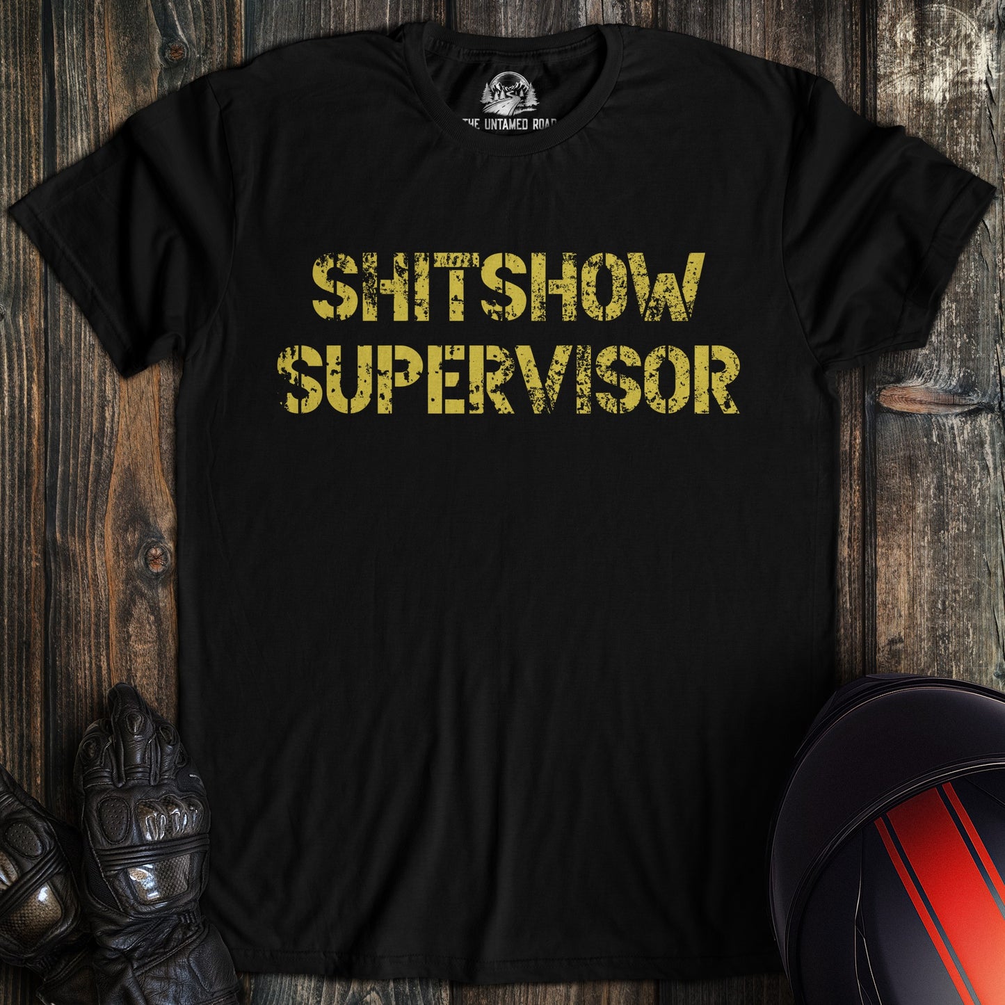 A black colored t-shirt with the words "shitshow supervisor" printed on the front.
