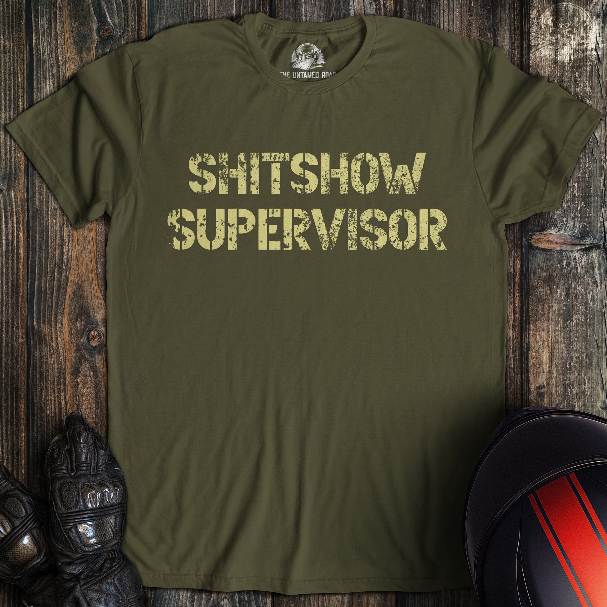 A military green colored t-shirt with the words "shitshow supervisor" printed on the front.