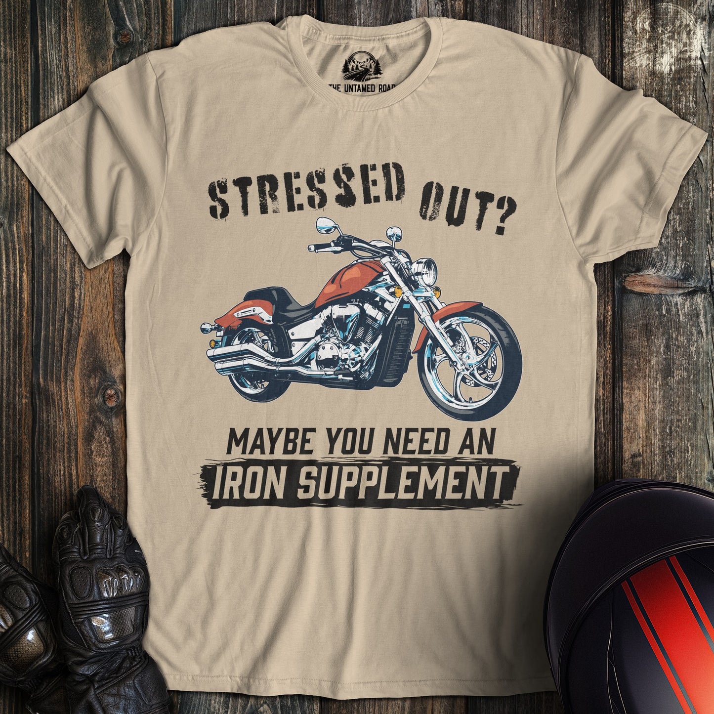 A sand colored t-shirt with the words "iron supplement" printed on the front.