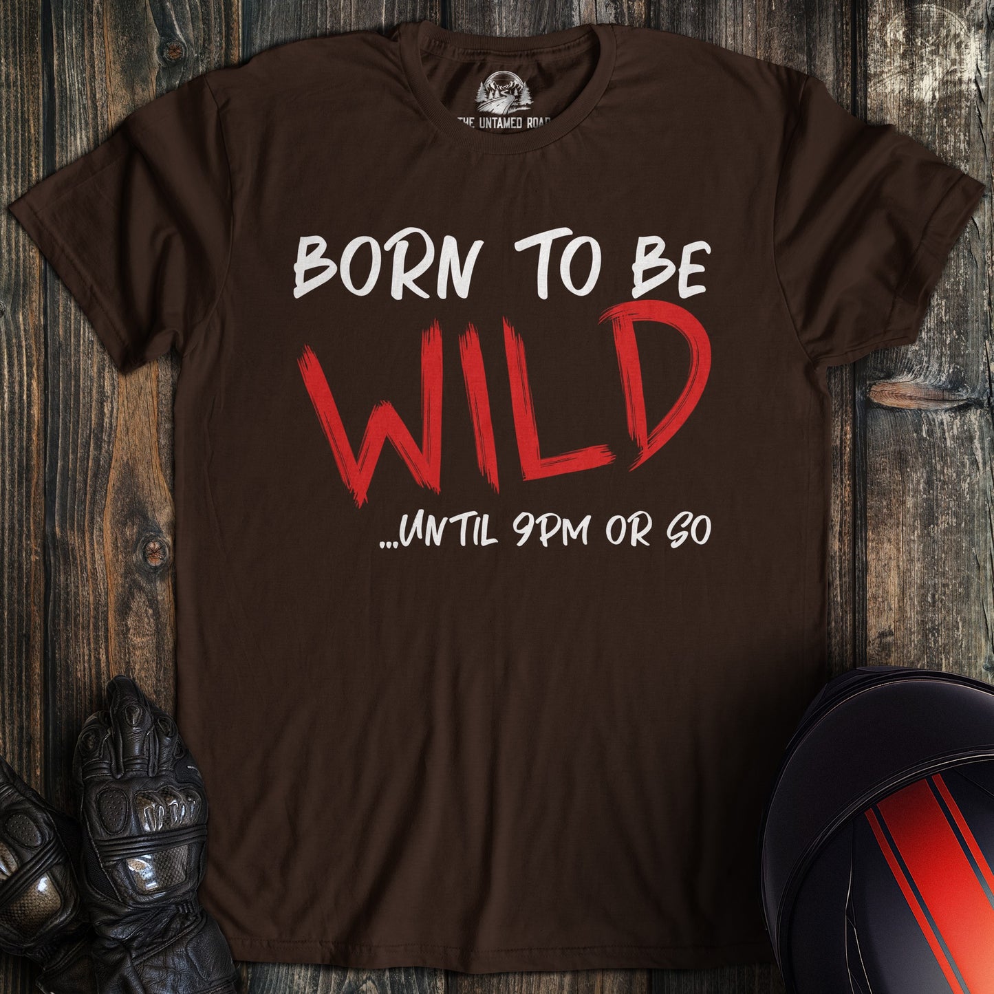 A dark chocolate colored t-shirt with the words "born to be wild" printed on the front.