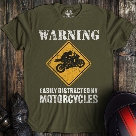 A military green colored t-shirt with the words "easily distracted" printed on the front.
