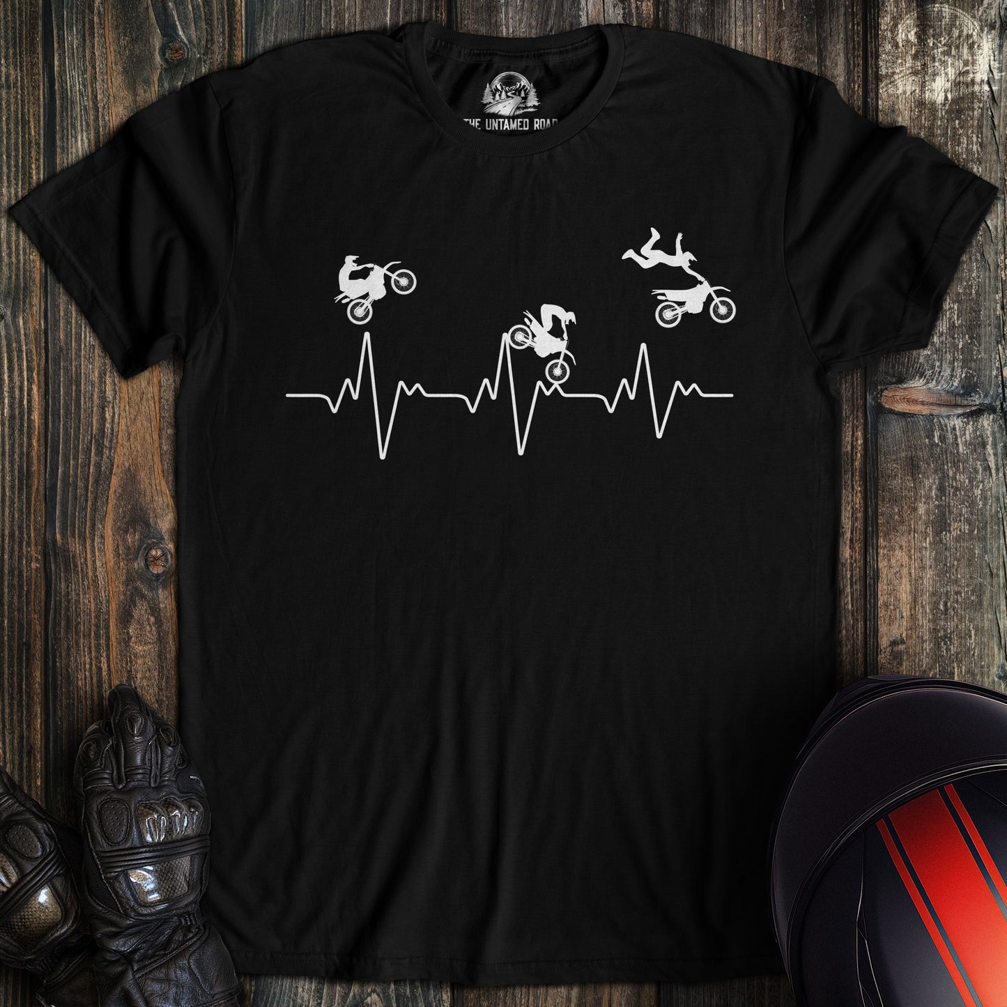 A black colored t-shirt with the words "dirtbike heartbeat" printed on the front.