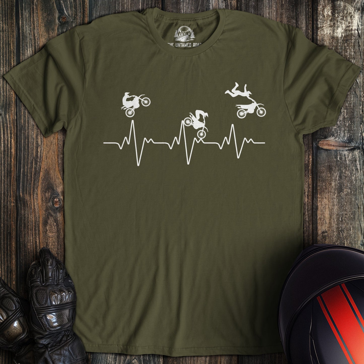 A military green colored t-shirt with the words "dirtbike heartbeat" printed on the front.