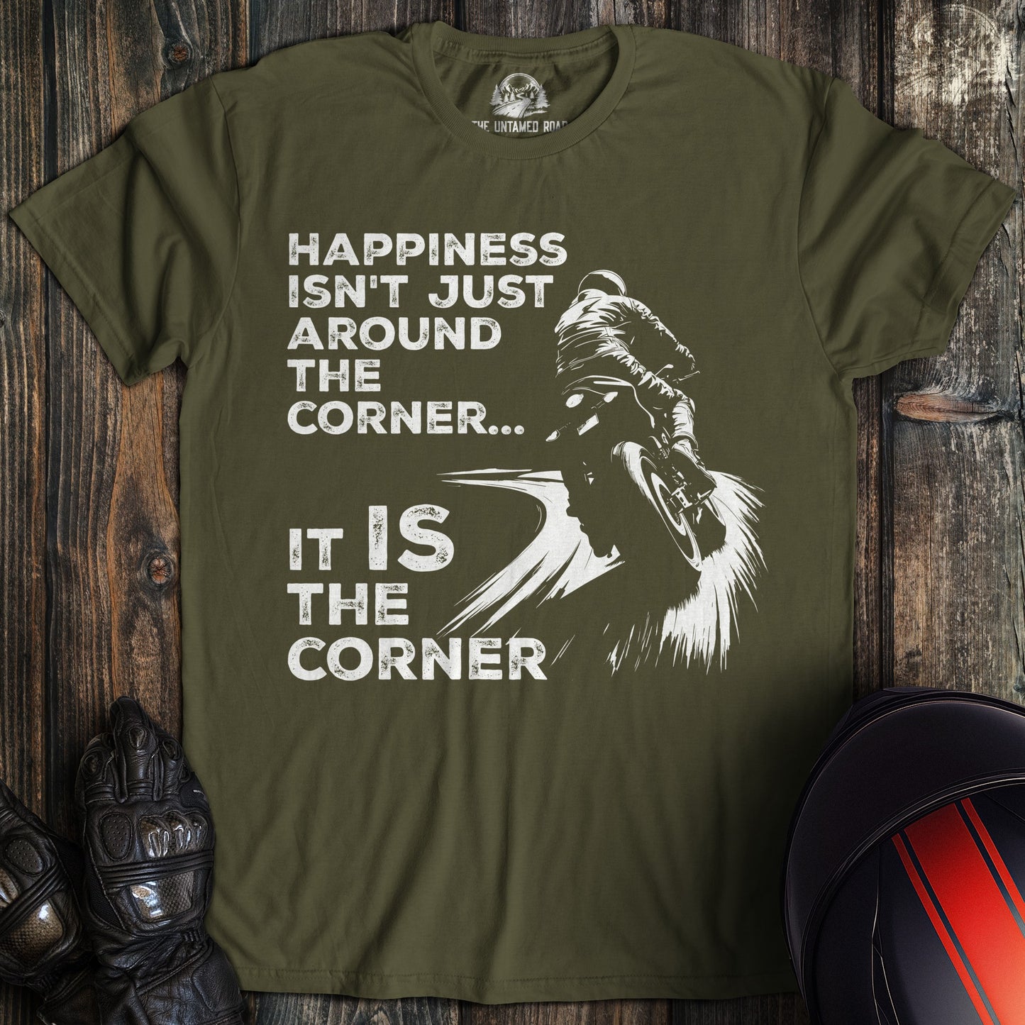A military green colored t-shirt with the words "happiness is the corner" printed on the front.
