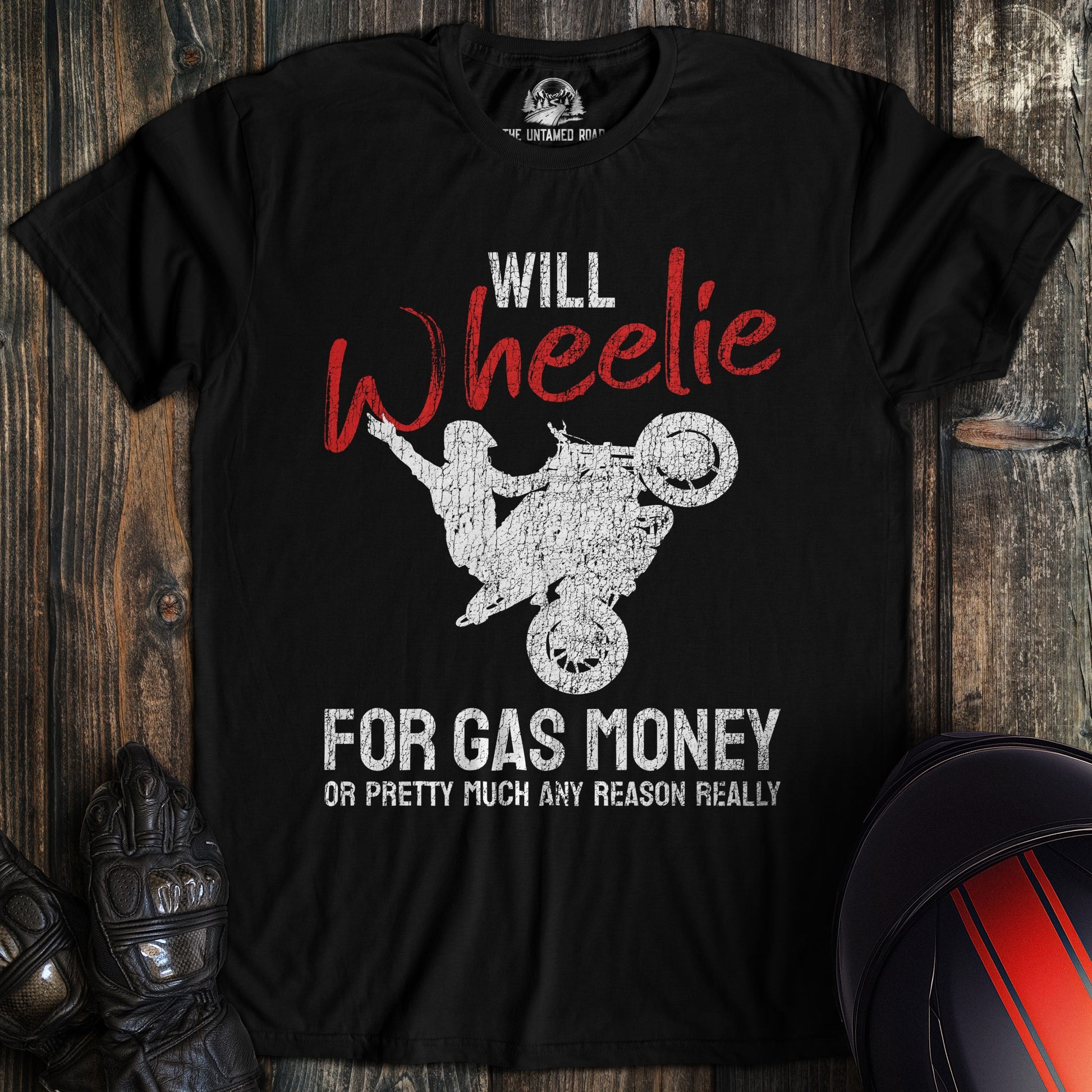A black colored t-shirt with the words "wheelie for money" printed on the front.