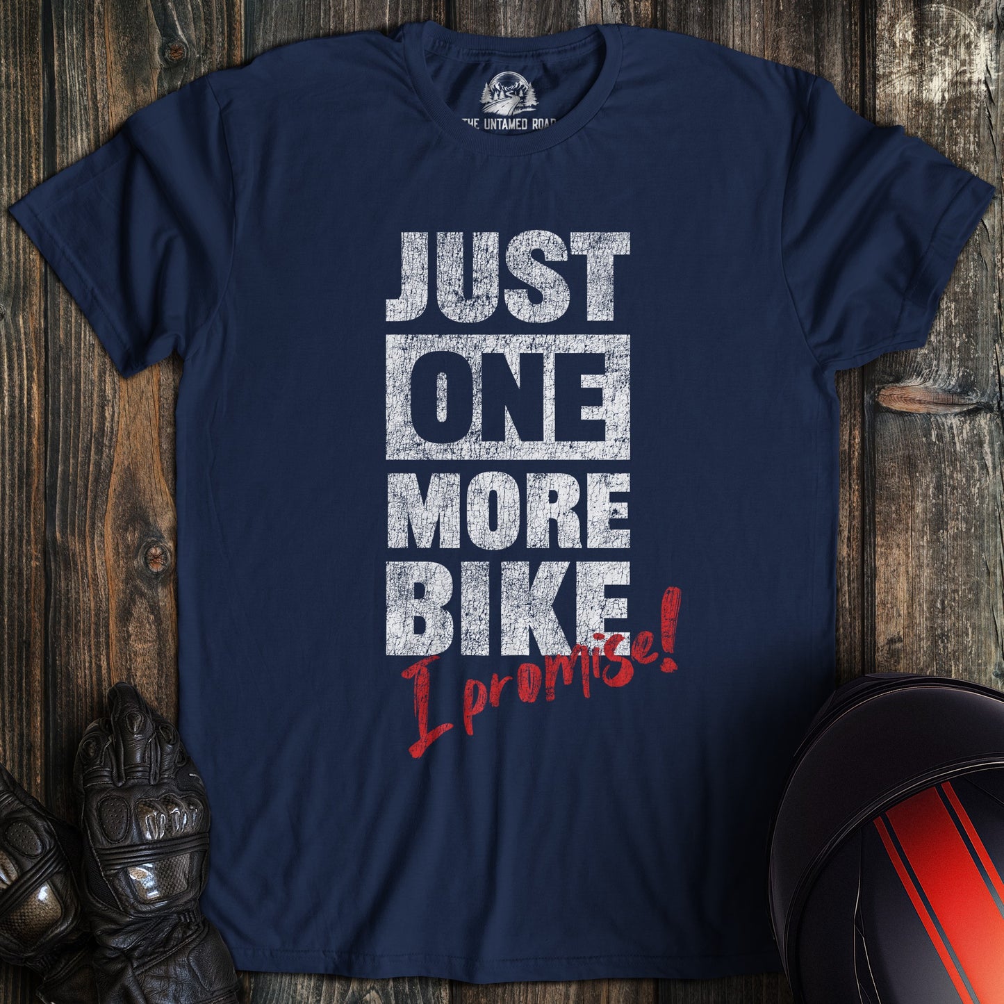 A navy colored t-shirt with the words "just one more bike" printed on the front.