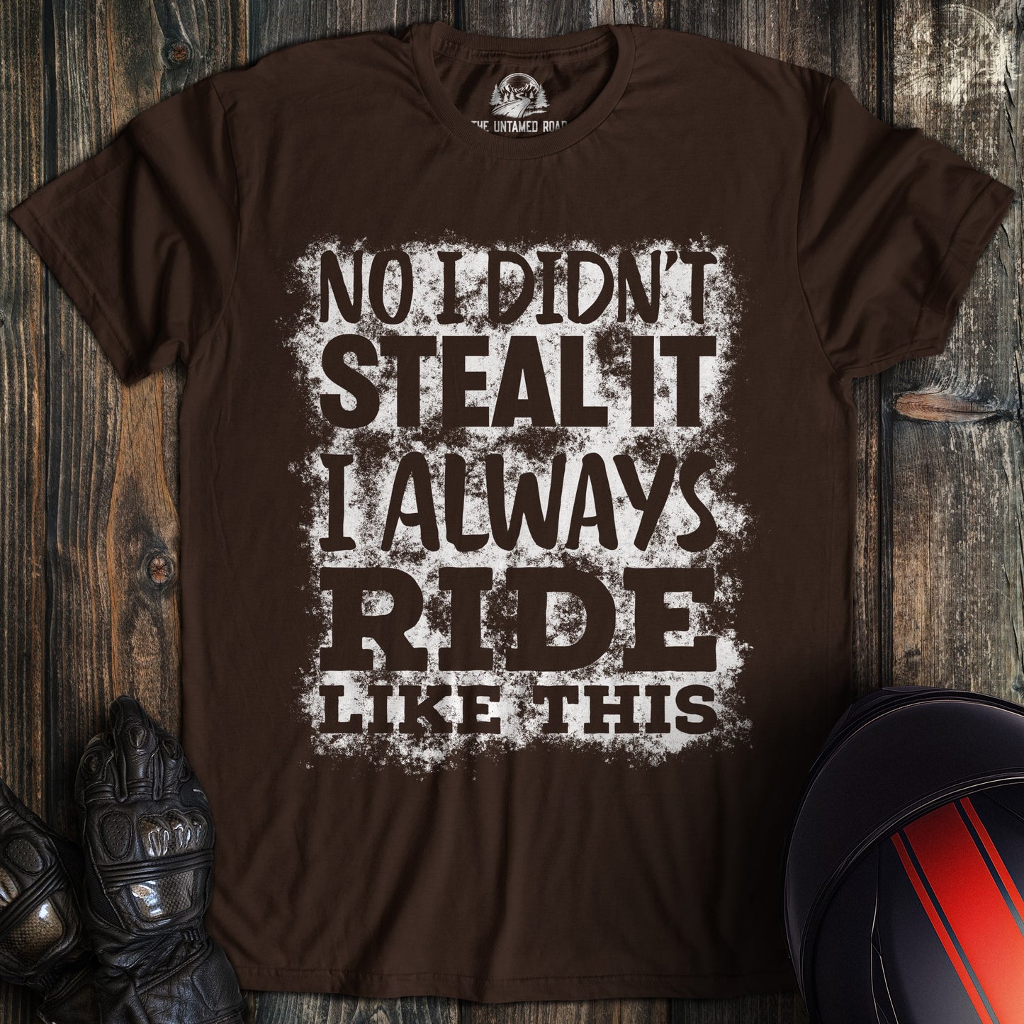 A dark chocolate colored t-shirt with the words "didnt steal it" printed on the front.