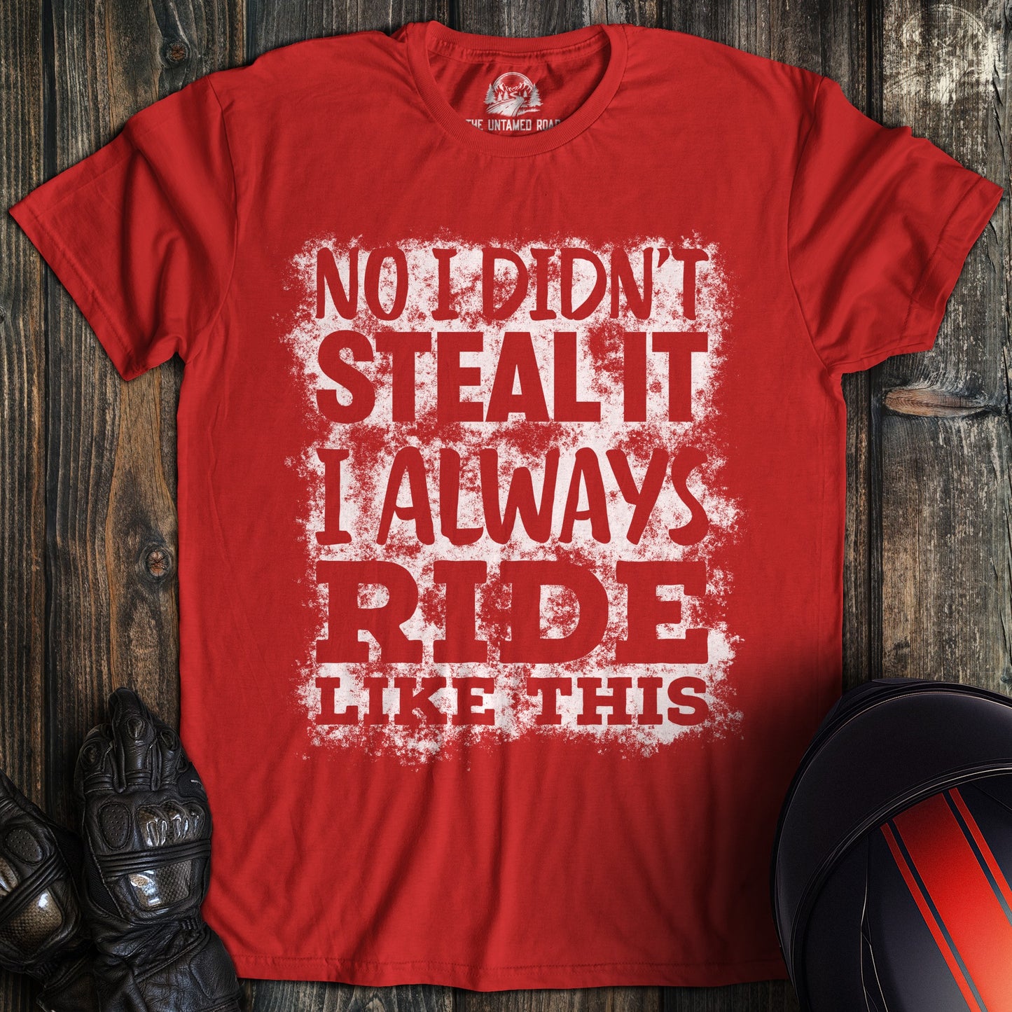 A red colored t-shirt with the words "didnt steal it" printed on the front.