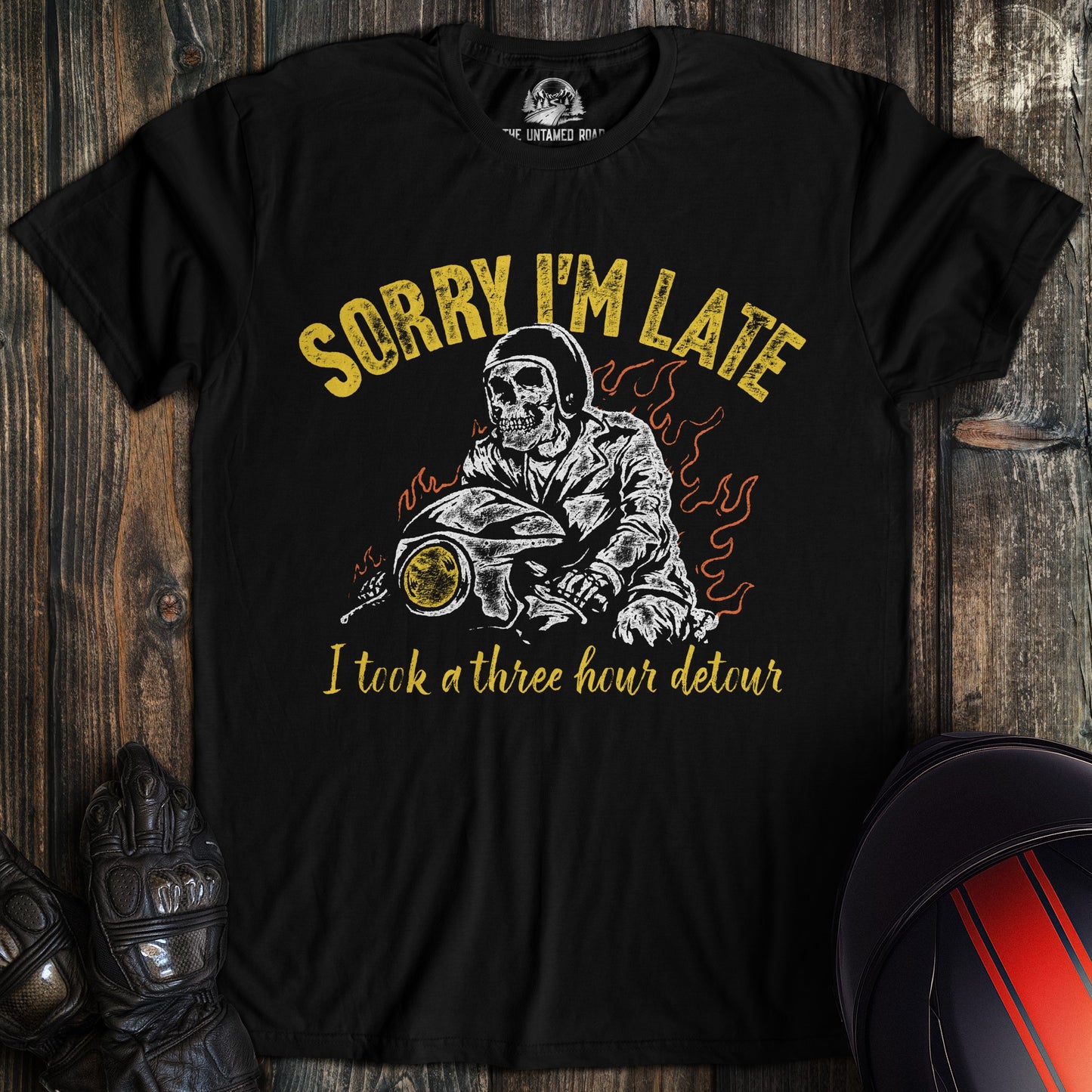 A black t-shirt featuring a skeleton biker on a motorcycle with the text, Sorry I'm Late I took a three hour detour.