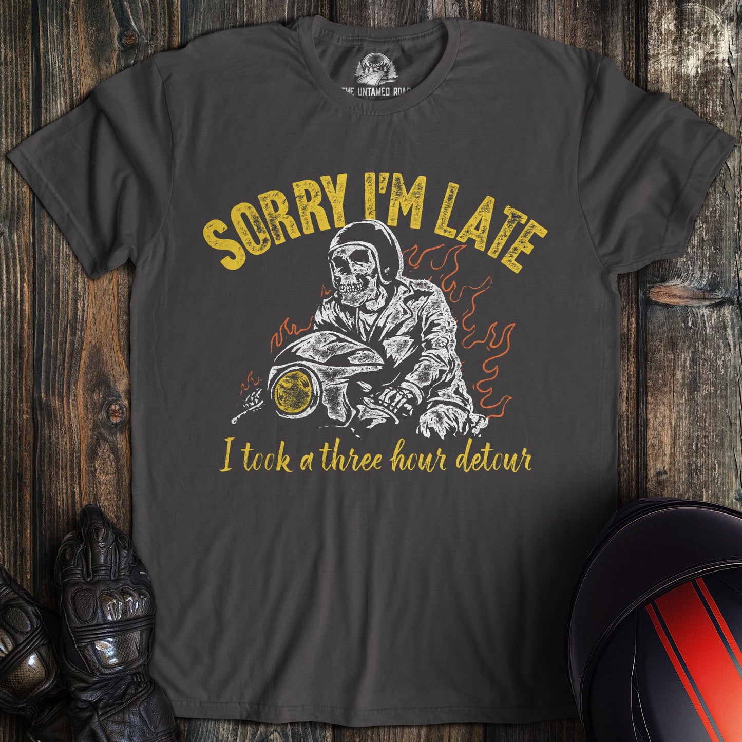 Charcoal gray t-shirt with a skeleton biker on a motorcycle and the text, Sorry I'm Late I took a three hour detour.