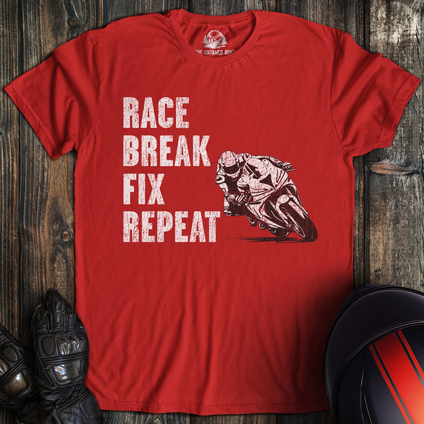 A red colored t-shirt with the words "race break fix" printed on the front.