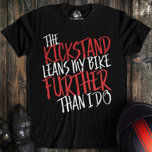 A black colored t-shirt with the words "kickstand leans further" printed on the front.