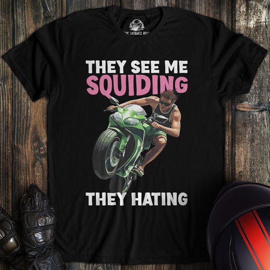 A black colored t-shirt with the words "squidding" printed on the front.