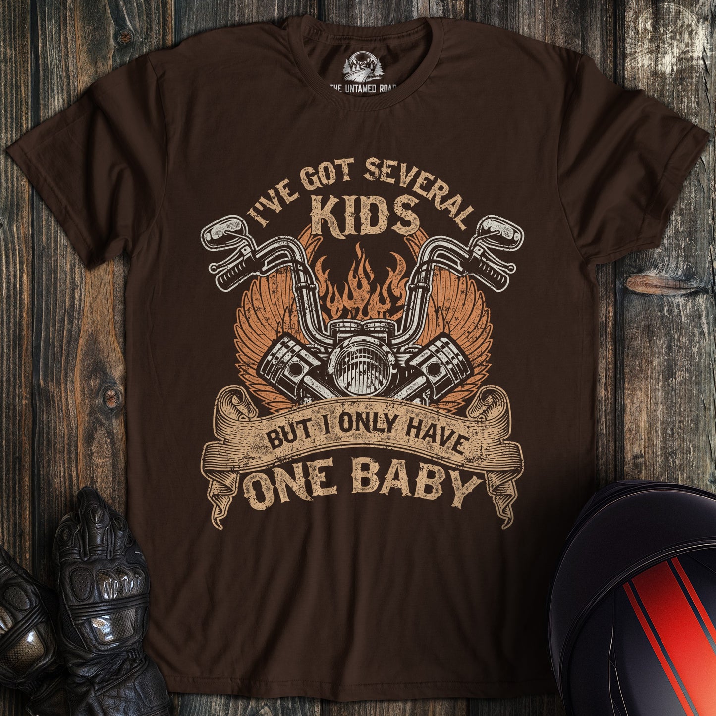 A dark chocolate colored t-shirt with the words "one baby" printed on the front.