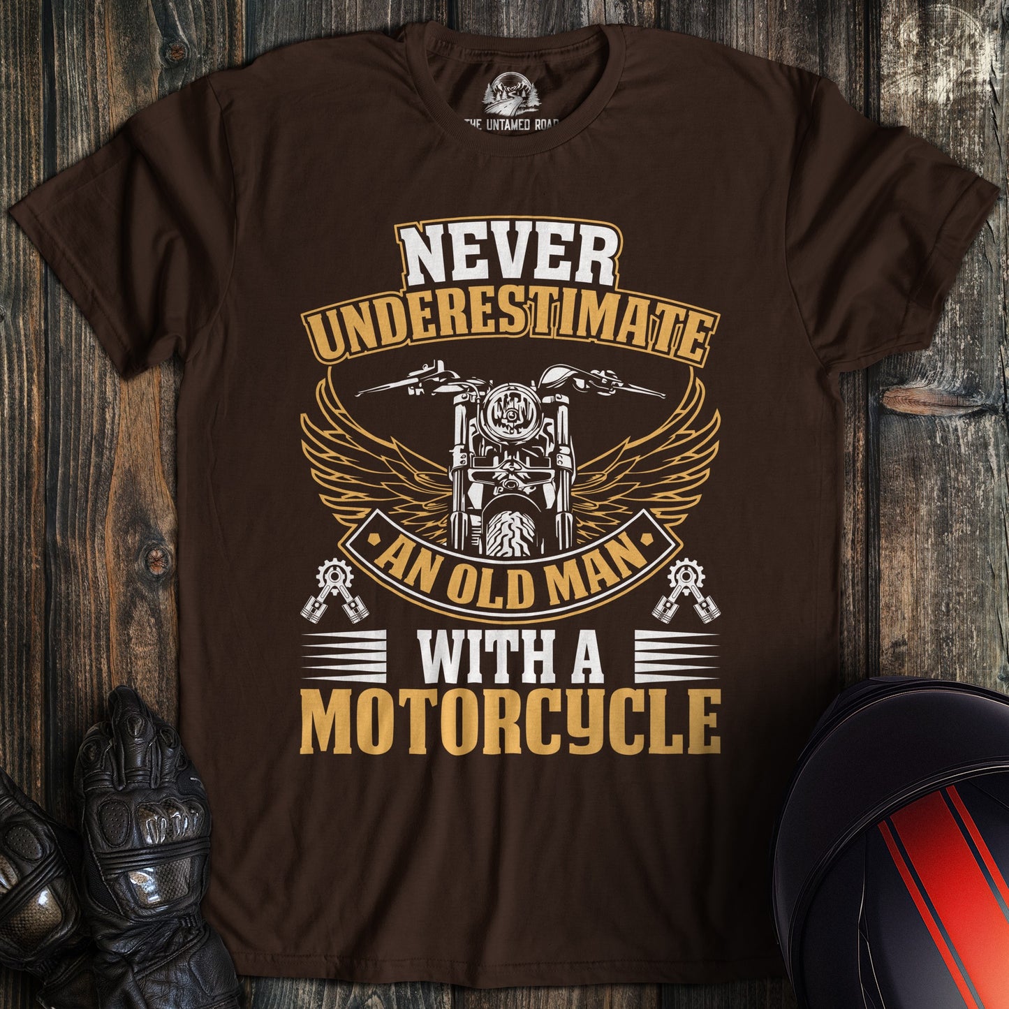 A dark chocolate colored t-shirt with the words "old man motorcycle" printed on the front.