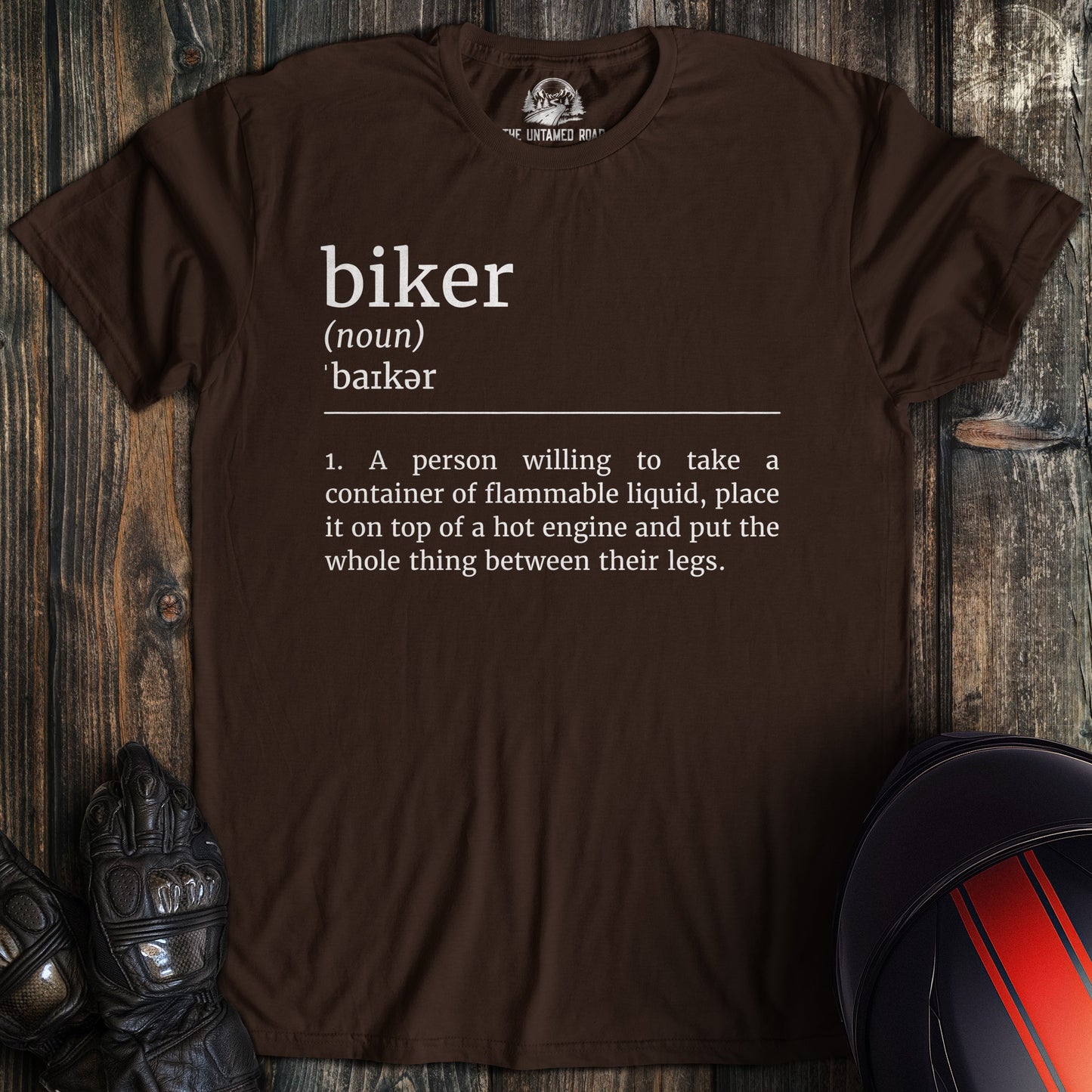 A dark chocolate colored t-shirt with the words "biker definition" printed on the front.