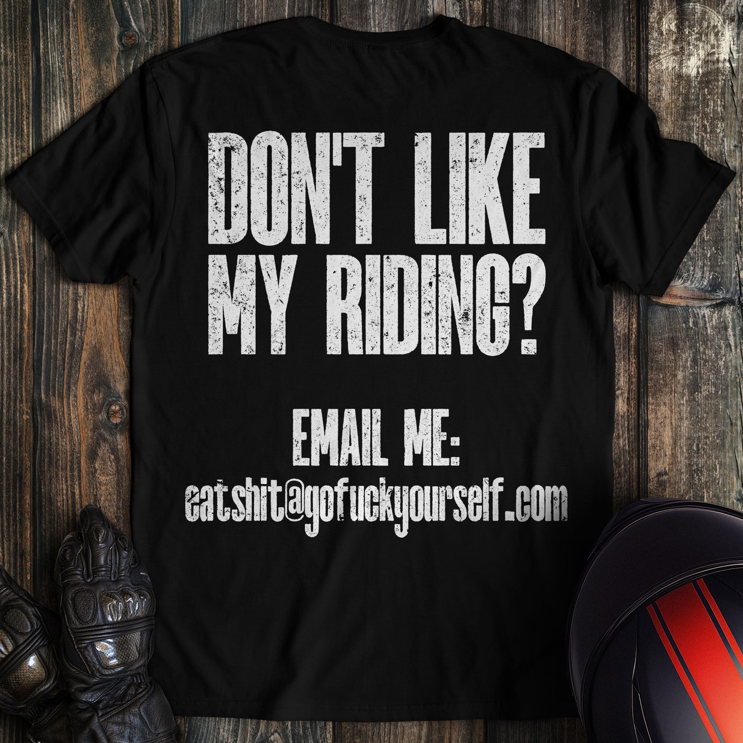 A black colored t-shirt with the words "dont like riding email" printed on the back.