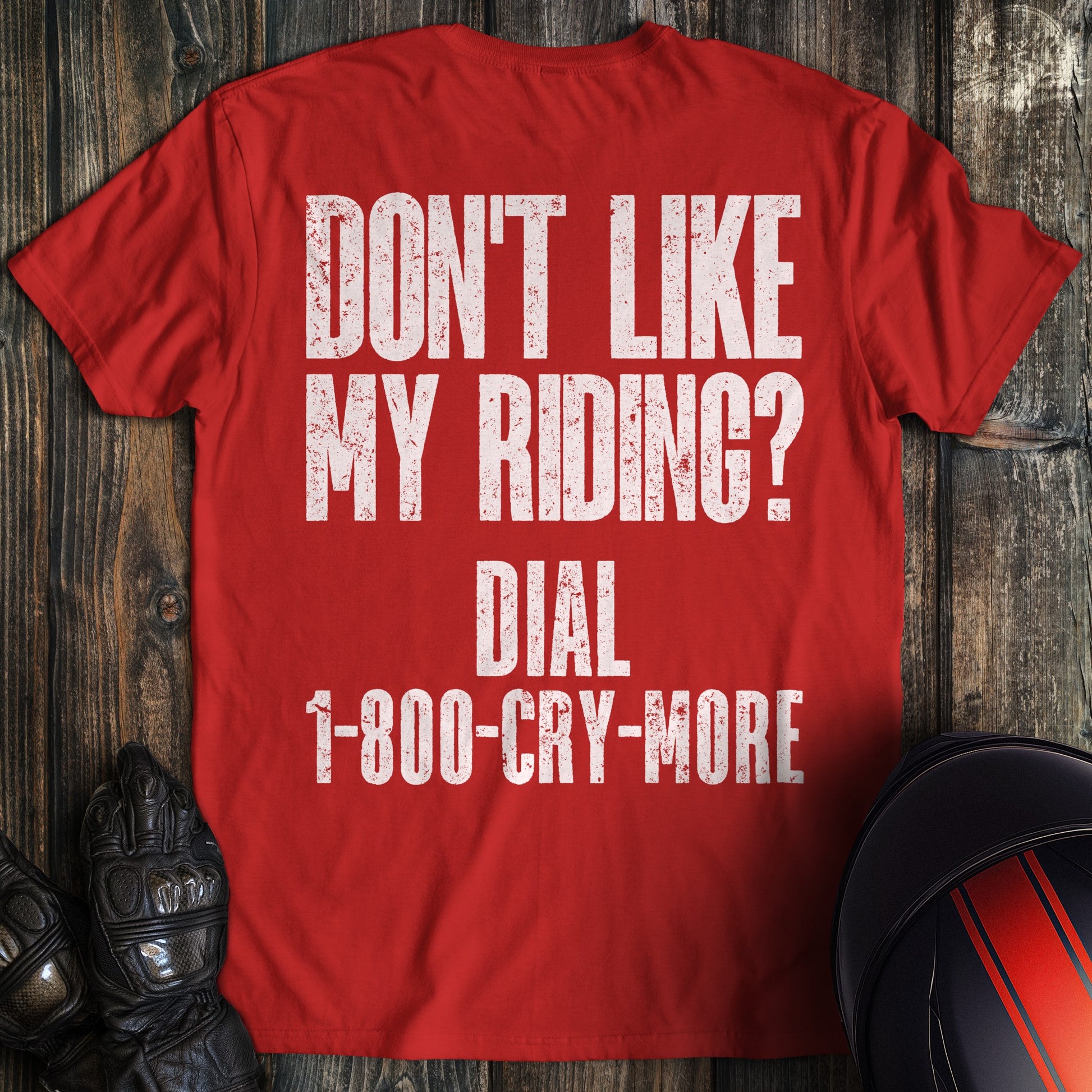 A red colored t-shirt with the words "riding complaint clean" printed on the back.