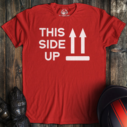A red colored t-shirt with the words "this side up" printed on the front.