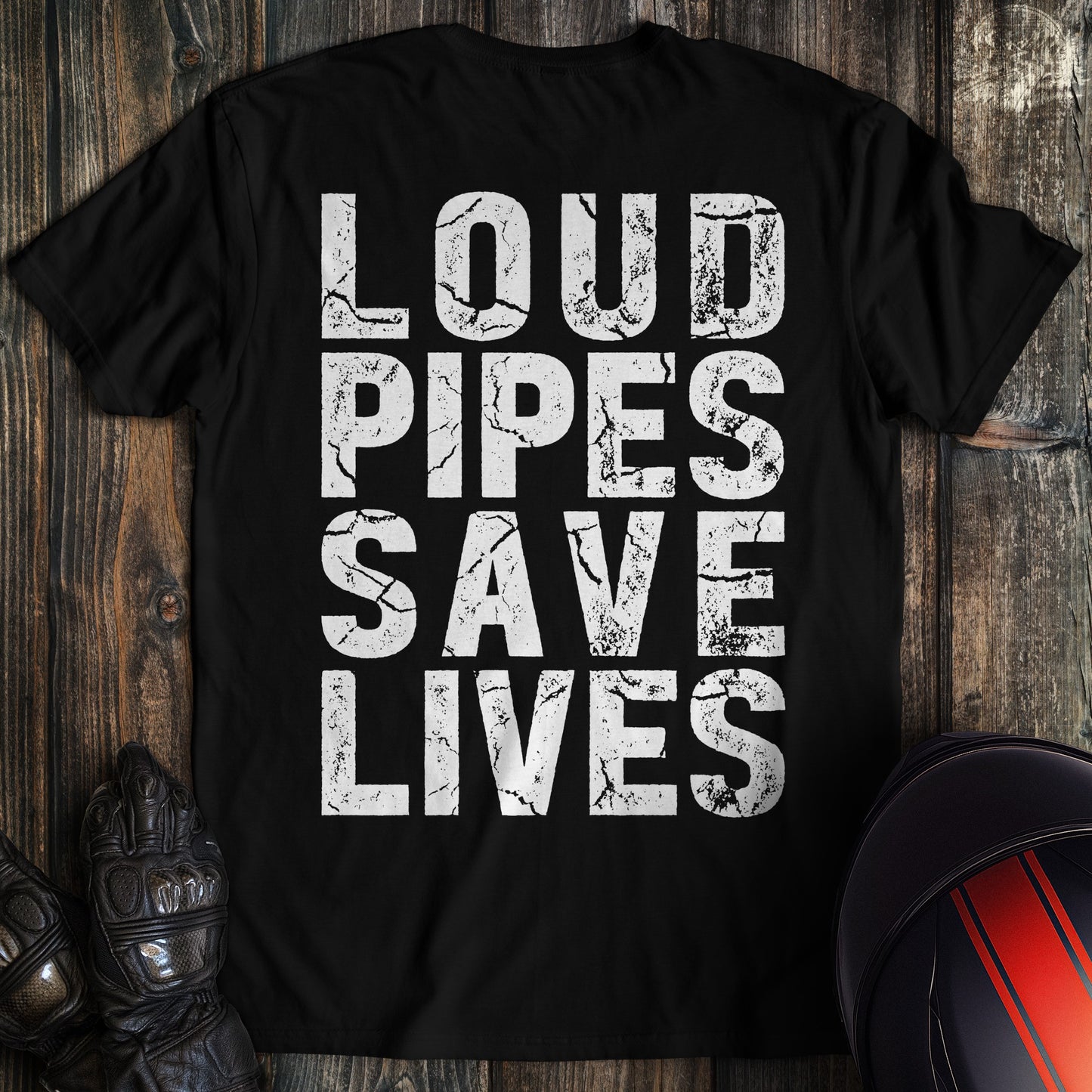 A black t-shirt featuring the words LOUD PIPES SAVE LIVES in a white, distressed block font.