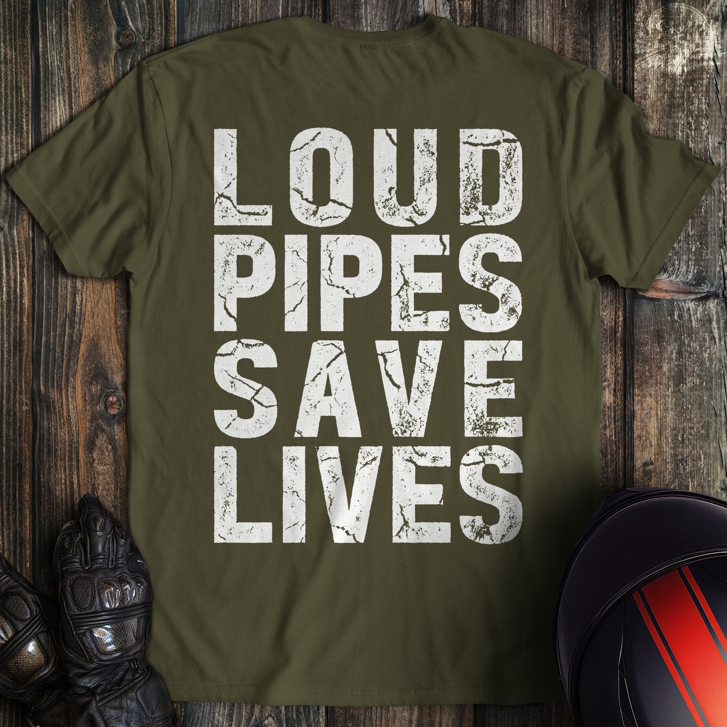 A military green biker t-shirt featuring the words LOUD PIPES SAVE LIVES in a white, distressed block font.