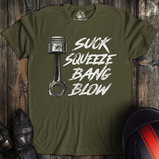 A military green colored t-shirt with the words "suck squeeze bang blow" printed on the front.