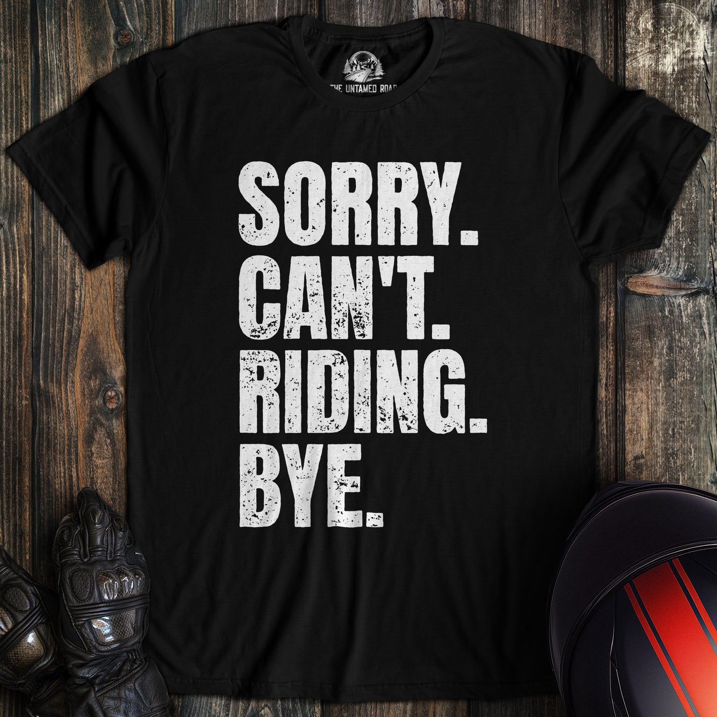 A black t-shirt with distressed white text that reads SORRY. CAN'T. RIDING. BYE. for a motorcycle biker.