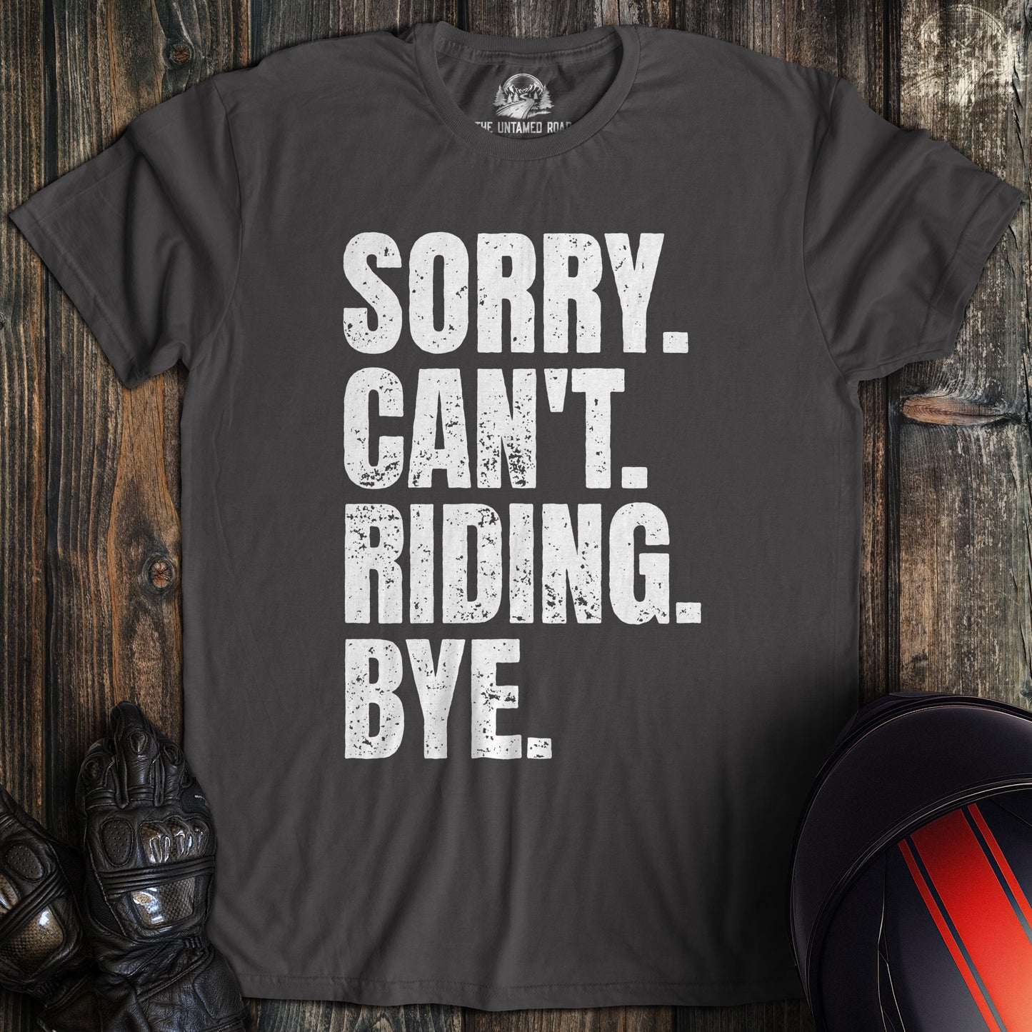 A charcoal gray t-shirt with distressed white text that reads SORRY. CAN'T. RIDING. BYE. for a motorcycle biker.