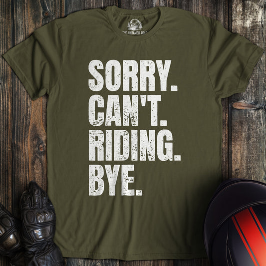 A military green biker t-shirt with distressed white text that reads, SORRY. CAN'T. RIDING. BYE.