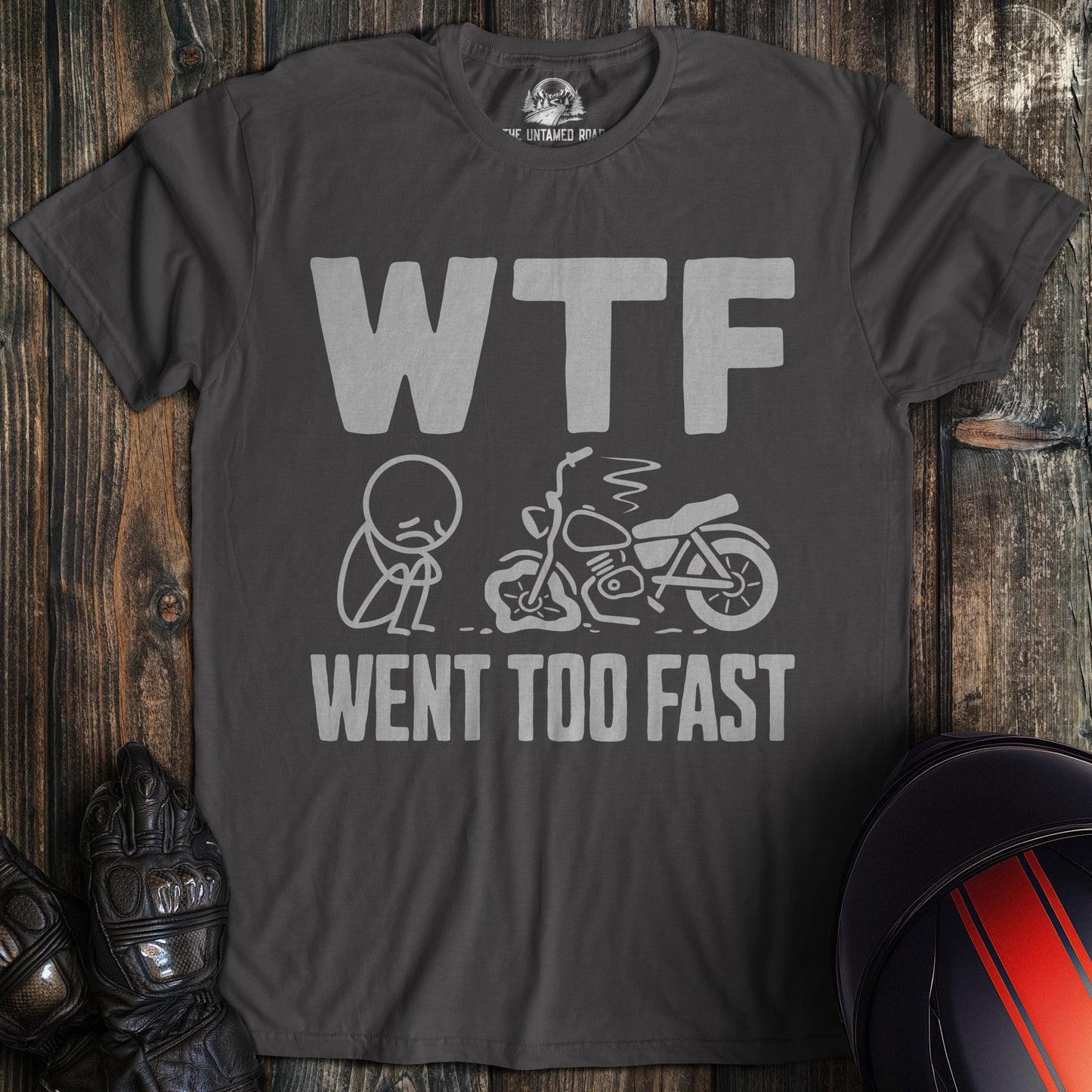 Charcoal gray t-shirt with a funny graphic of a sad biker next to a crashed motorcycle and the text WTF WENT TOO FAST.