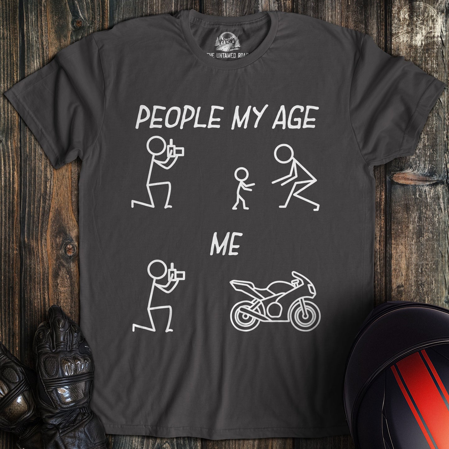 A charcoal gray t-shirt with a funny graphic comparing people my age with kids to me with a motorcycle.