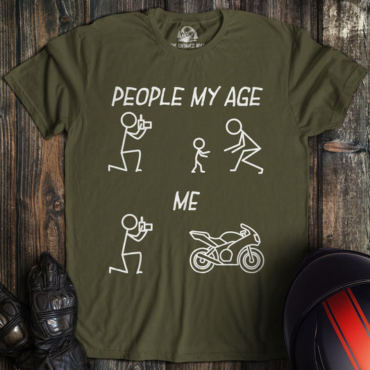 A military green t-shirt with a funny graphic comparing people my age with kids to me with a motorcycle.