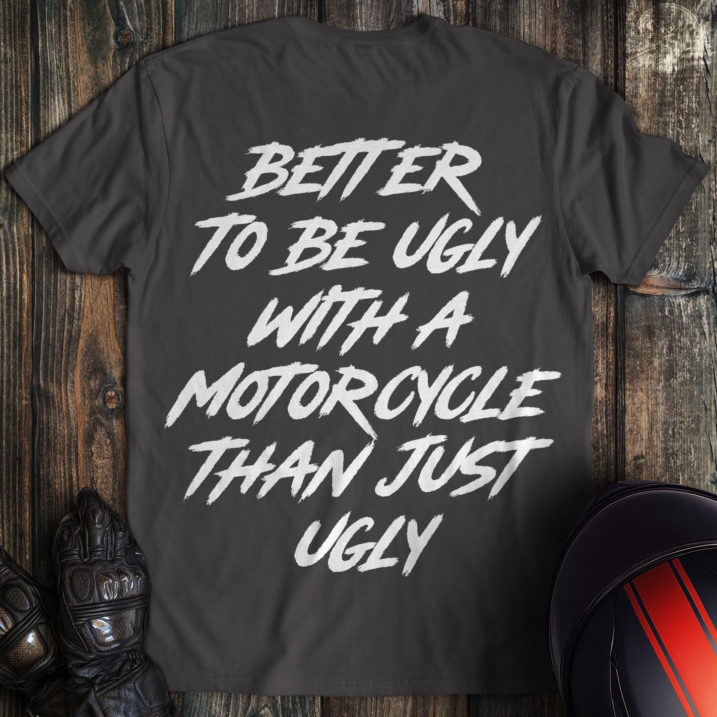 A charcoal gray t-shirt featuring the text Better To Be Ugly With A Motorcycle Than Just Ugly in a white brush font.