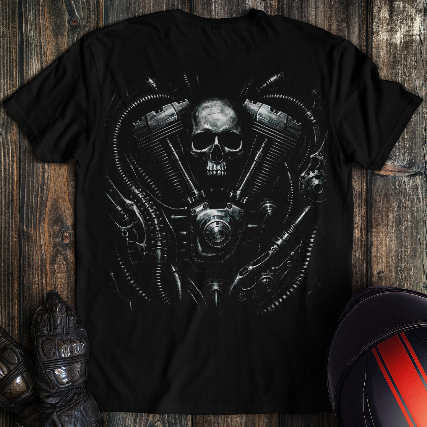 A black biomechanical t-shirt featuring a skull integrated into a detailed motorcycle engine with gears and hoses.