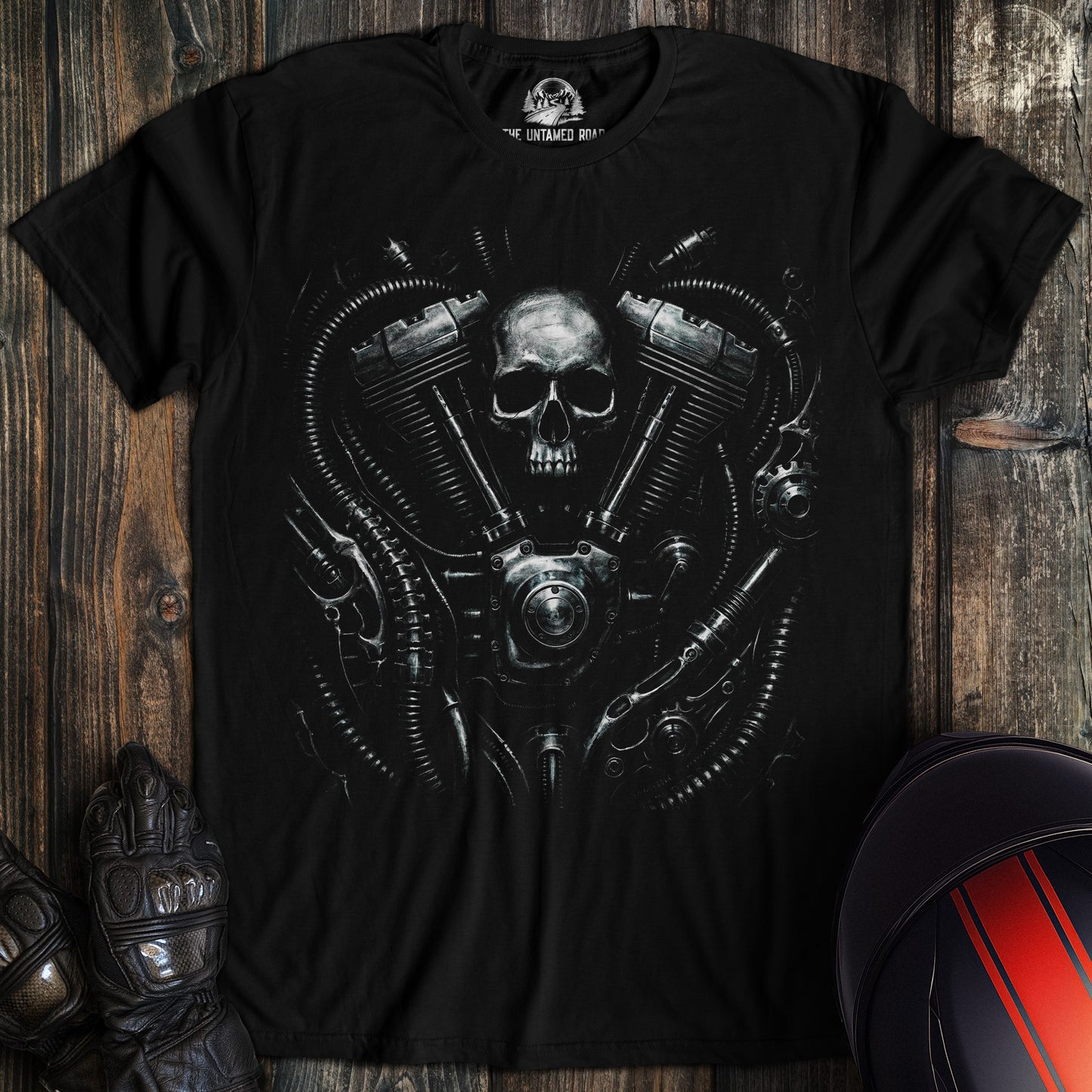A black t-shirt featuring a biomechanical graphic of a skull integrated with a motorcycle engine and metallic tubes.