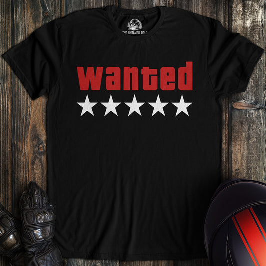 A black t-shirt featuring the word 'wanted' in red block letters above five white stars.