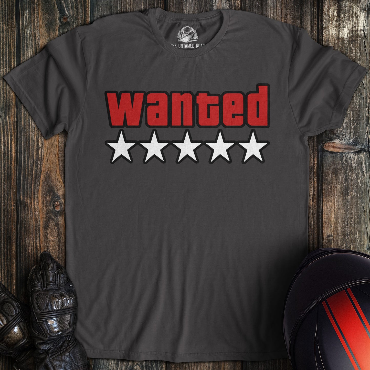 Charcoal gray t-shirt featuring the word WANTED in red block letters above five white stars.