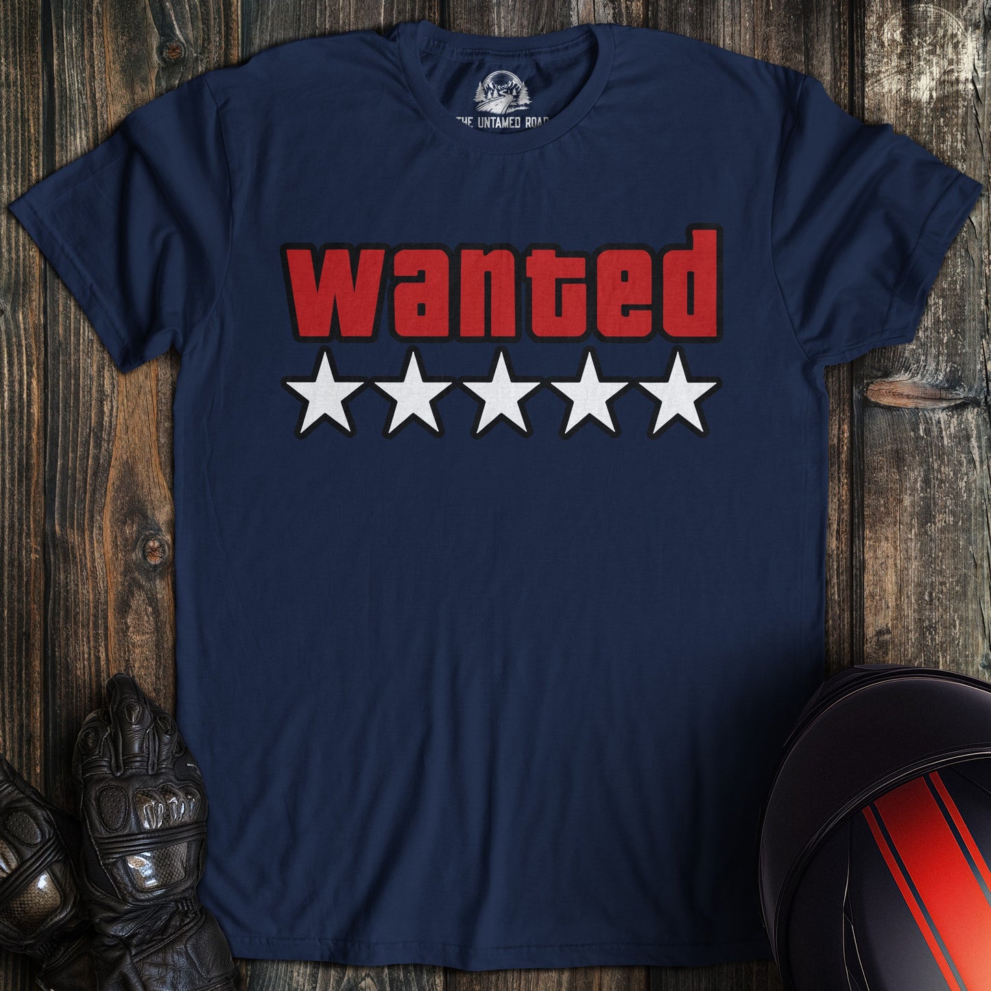A navy blue t-shirt featuring the word WANTED in red block letters above five white stars.