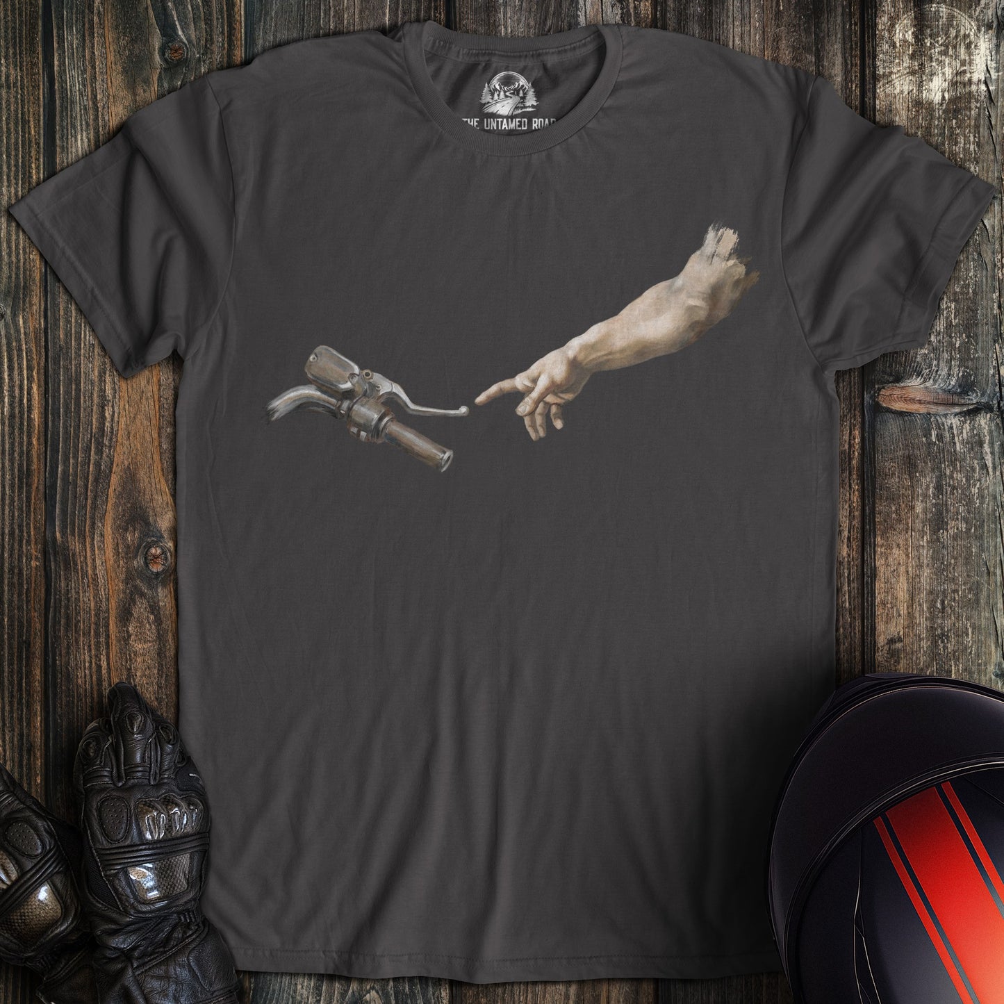 Charcoal gray t-shirt featuring a hand reaching toward a motorcycle handlebar in the style of The Creation of Adam.