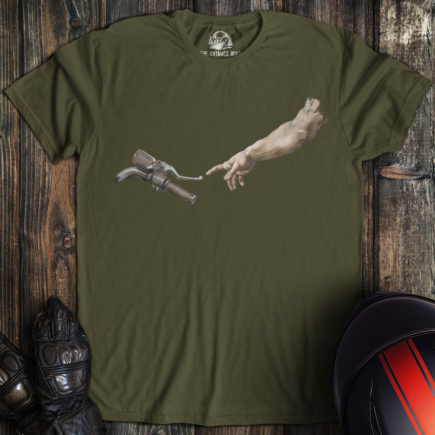 A military green t-shirt featuring a funny graphic of a hand reaching for a motorcycle handlebar in a creation parody.