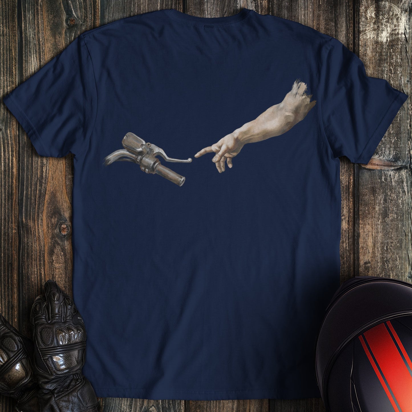 A navy blue t-shirt featuring a funny biker graphic of a hand reaching for a motorcycle handlebar in a creation style.